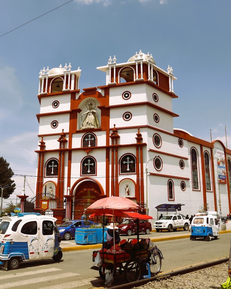 a large white and red building with a clock on it's side